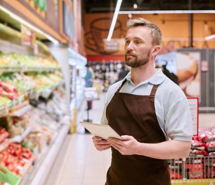 An employee at retail store with Smile™️ enterprise dental cover